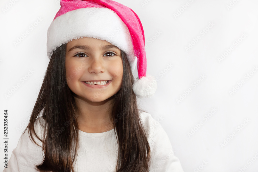 Christmas time - happy smiling girl in Santa hat isolated on white background. Christmas time - happy smiling girl in Santa hat isolated on white background.