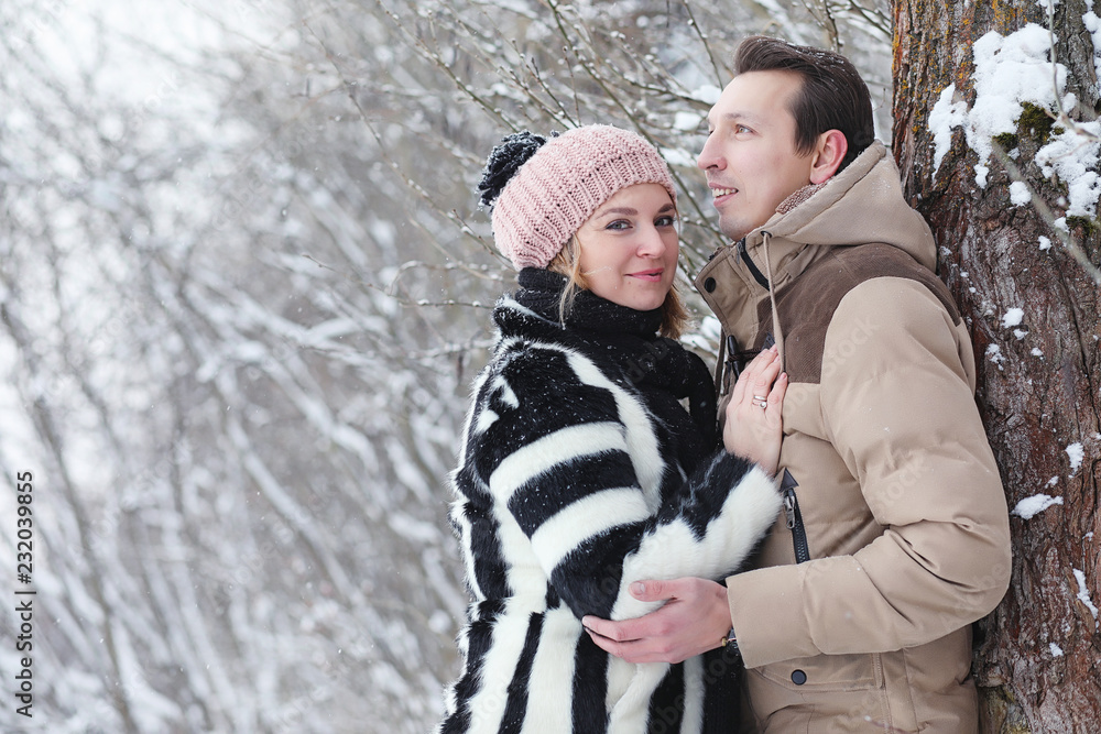 Young family with children are walking in the winter park. Winter walk of parents with children. Walking on a holiday weekend in the winter.