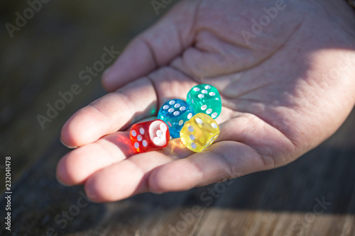 hand throwing the color dice. dice falling. hand rolling dice