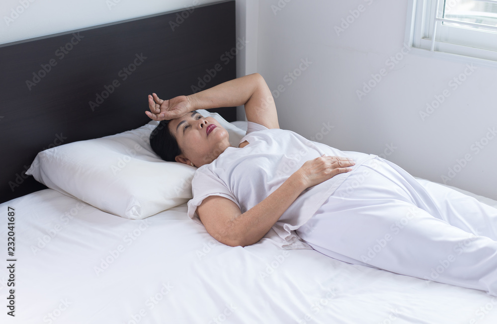 Asian elderly woman depression have a headache and feeling be gloomy in bedroom,Insomnia disease Asian elderly woman depression have a headache and feeling be gloomy in bedroom,Insomnia disease