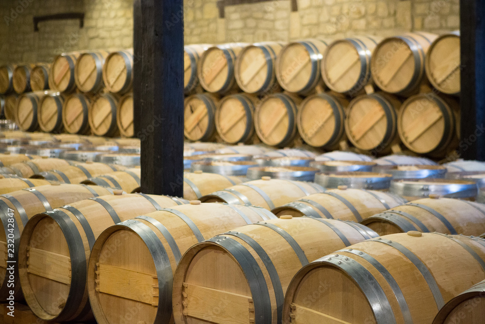 Wine wooden barrels in a storehouse Wine wooden barrels in a storehouse