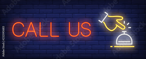 Call us neon sign. Hotel bell and guest hand on brick wall background. Vector illustration in neon style for hotels and motels wall signs