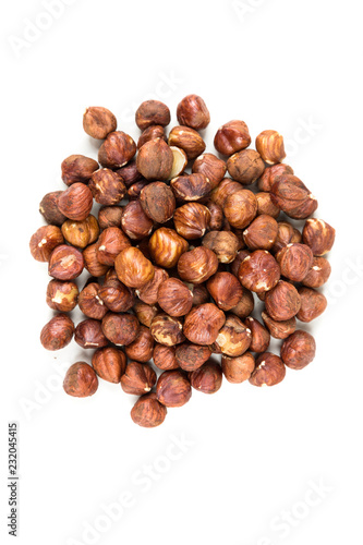Pile of whole unshelled hazelnuts isolated