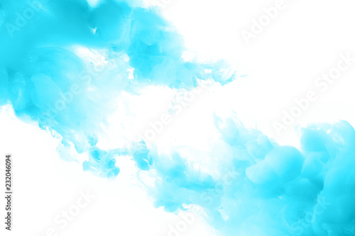 Blue ink splashes in the water. Abstract background