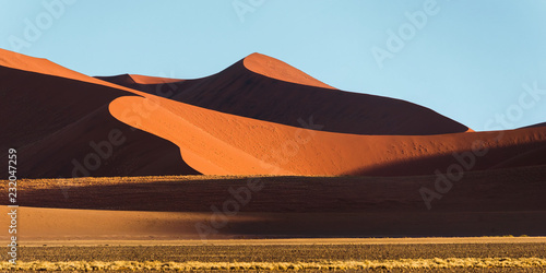 Panoramic view of a Sossusvlei big orange sand dune against blue sky  Namibia