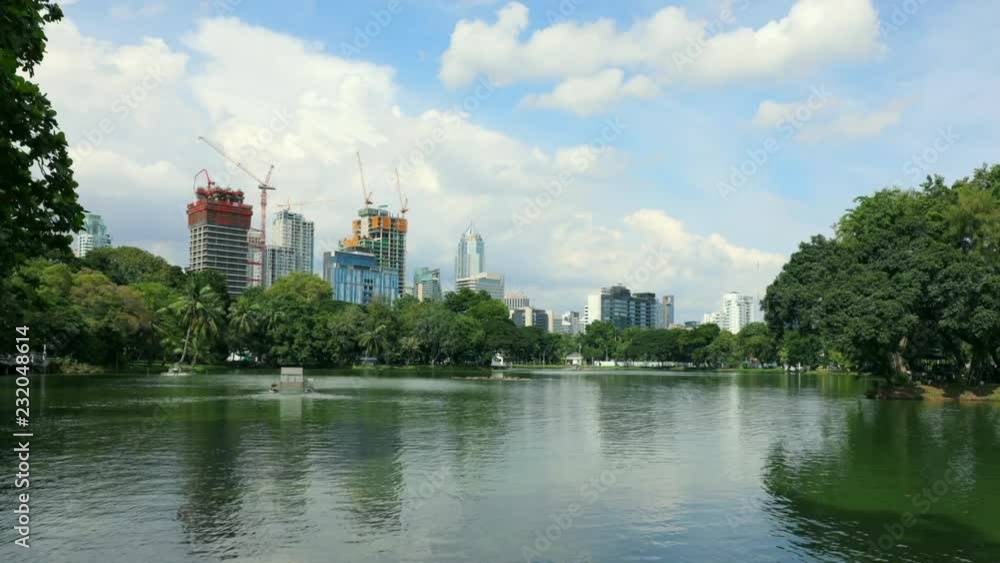 timelapse of a lake in lumpini park in Bangkok during day , Thailand , Southeast Asia