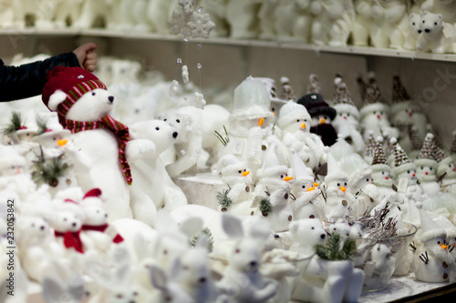 All white christmas gifts souvenirs and toys on the advent market stall: bears, rabbits, snowmen,