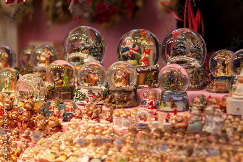 Christmas snow globes souvenirs on the advent market stall, close up