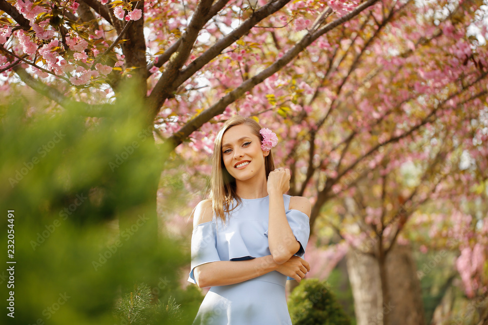 Beautiful girl posing in blue dress in park Beautiful girl posing in blue dress in park