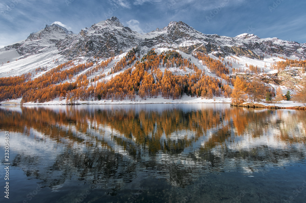 Engadine valley in Switzerland. Autumn reflection in the lake