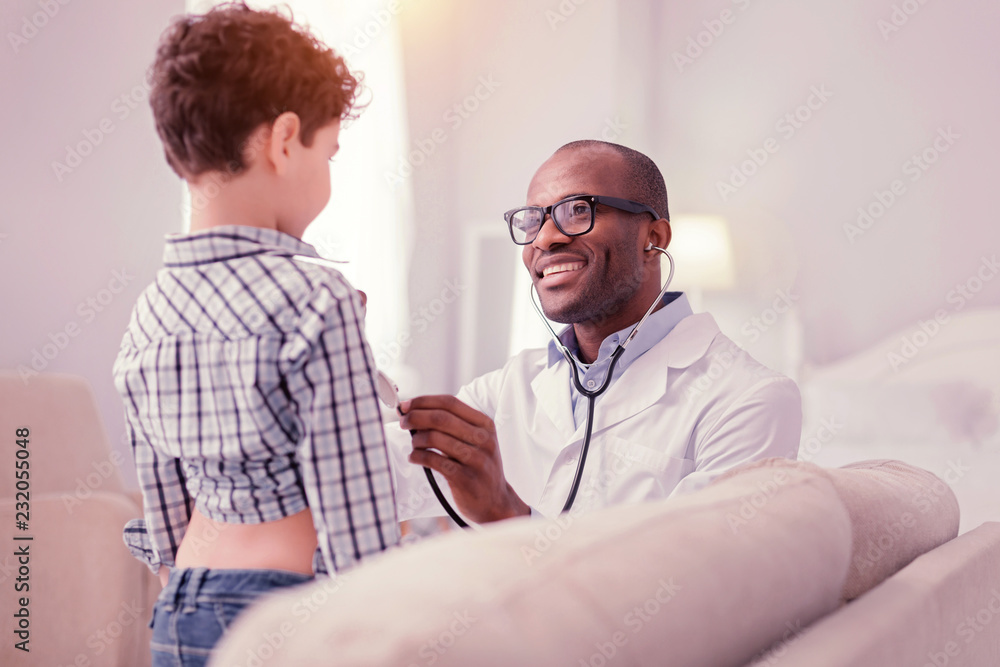 Fototapeta premium Nice positive man enjoying the procedure of medical examination