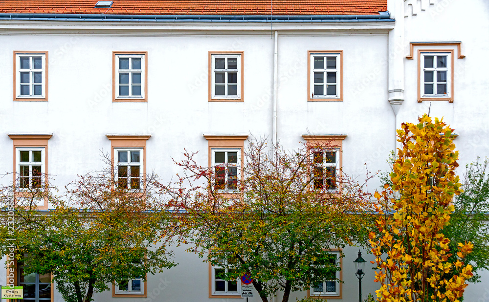 autumn foliage and white facade