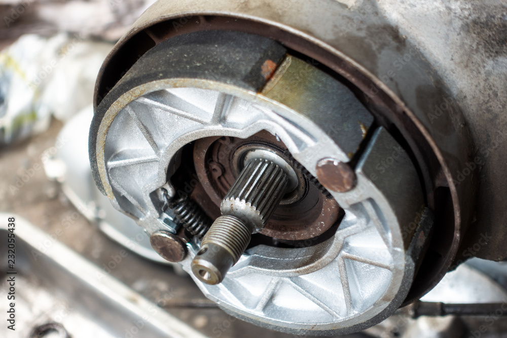 Old motorcycle drum brake pad in opened engine box