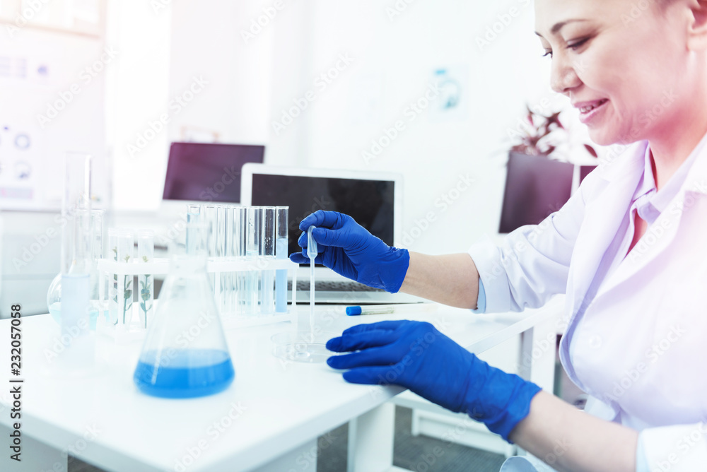 Fototapeta premium Positive intelligent woman taking a test sample