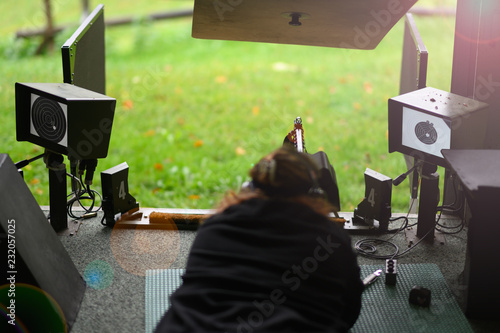 Woman with assault rifle on a shooting range in Switzerland