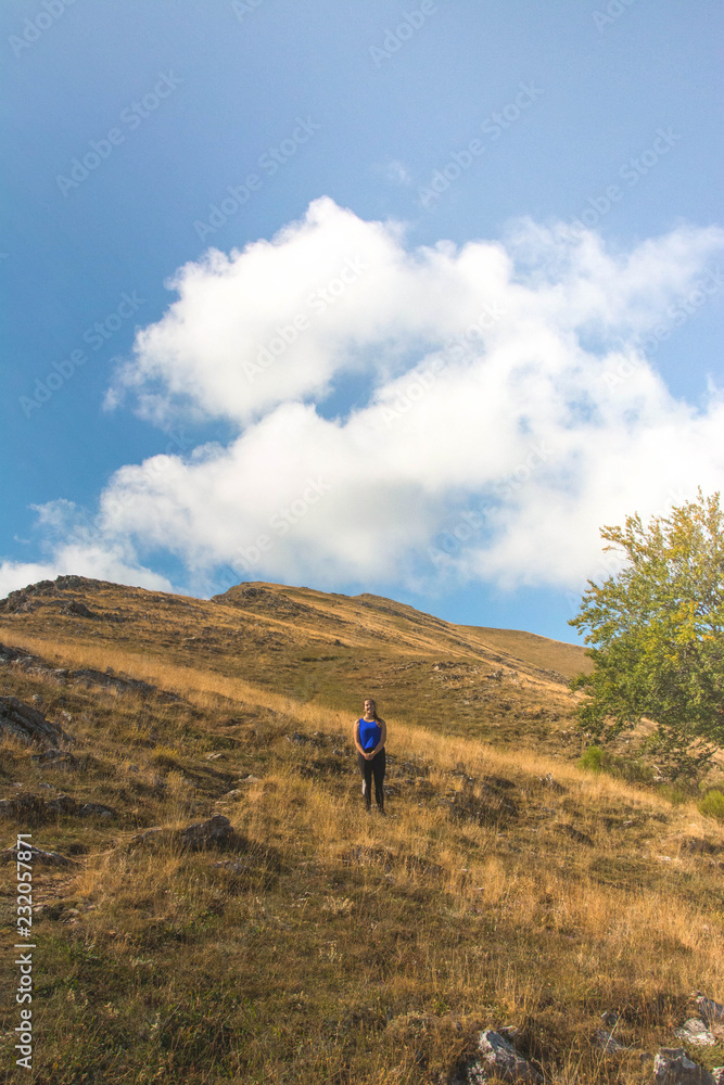 Anonymous person standing on hill Anonymous person standing on hill