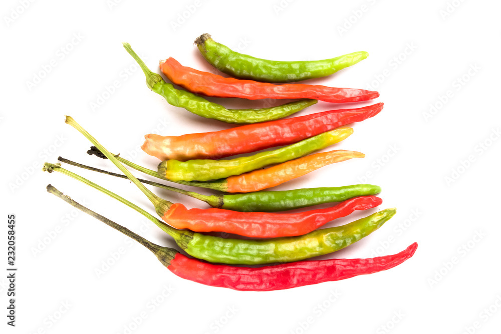 Close-up of colorful hot peppers. Group of red green and yellow peppers on white background