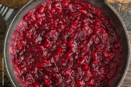 Traditional cranberry sauce in black cast-iron skillet, top view