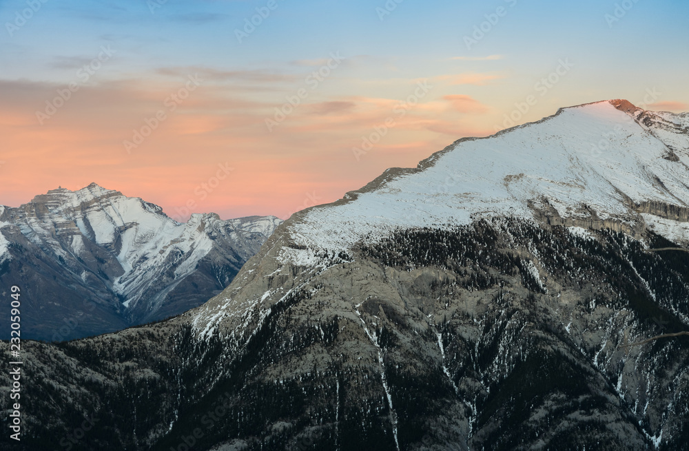 Beautiful snow capped mountains against the twilight sky at Banff National Park in Alberta, Canada.