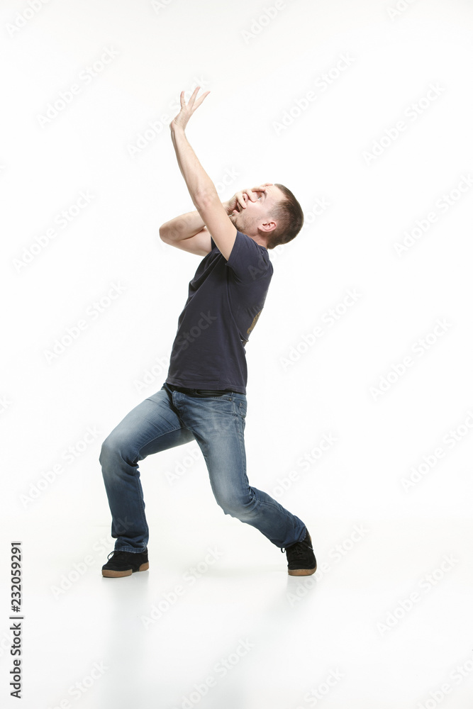 The young cool man full body scared pose at white studio The young cool man full body scared pose at white studio