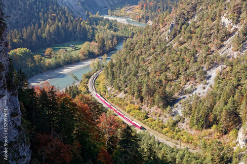 Train in sunny autumnal Ruinaulta - Rheinschlucht (Rhine canyon), Illanz/Glion - Reichenau, Switzerland photo