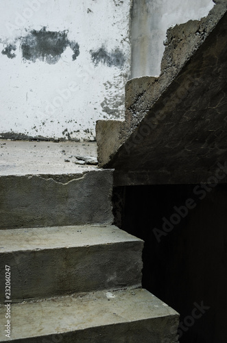 Fototapeta Naklejka Na Ścianę i Meble -  unfinished cement stairs, perspective of crossed concrete stairs