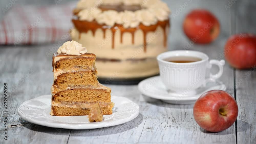 Piece of Caramel Apple Cake with spices, cinnamon, creamy caramel in autumn style.