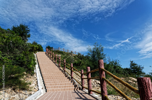 Road  fence and blue sky  climbing up the hill