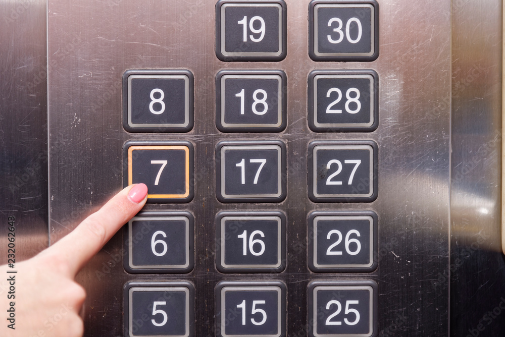 Elevator buttons with finger pushing 7 floor Elevator buttons with finger pushing 7 floor