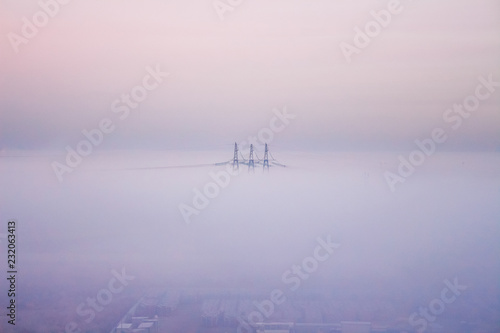 Fog in the city. Fog covers electrotowers. Morning landscape