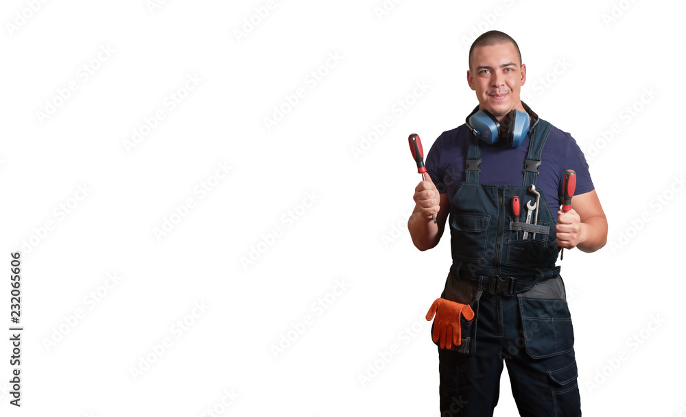 Strong male mechanic in blue overal standing on a white isolated background Strong male mechanic in blue overal standing on a white isolated background