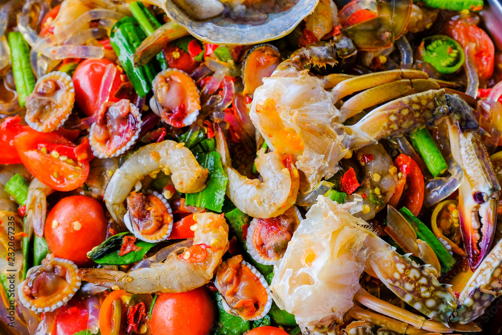 Som Tam Seafood (Spicy Papaya Salad) with salted crab, on wooden table ( Thai food) Som Tam Seafood (Spicy Papaya Salad) with salted crab, on wooden table ( Thai food)