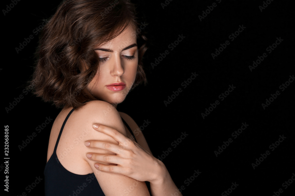 Portrait of beautiful young woman on dark background Portrait of beautiful young woman on dark background