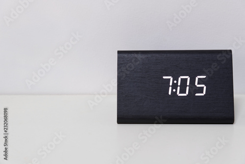 Black digital clock on a white background showing time 7:05