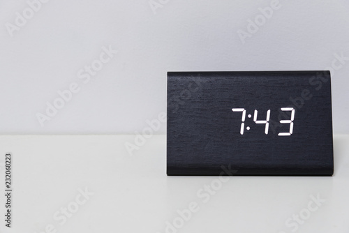 Black digital clock on a white background showing time 7:43 photo