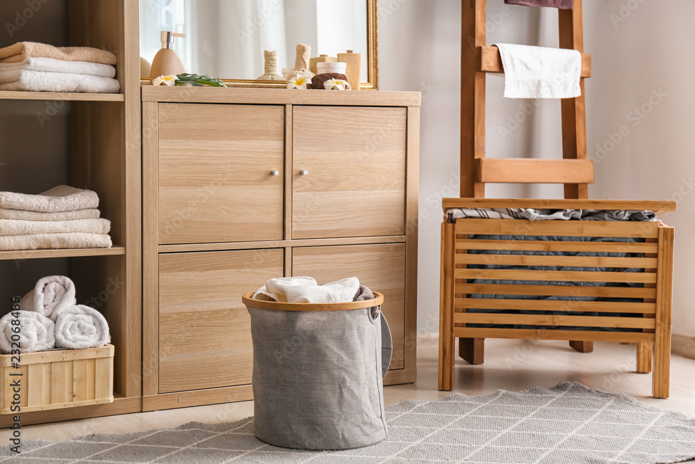 Laundry basket with dirty towels on floor in bathroom Laundry basket with dirty towels on floor in bathroom