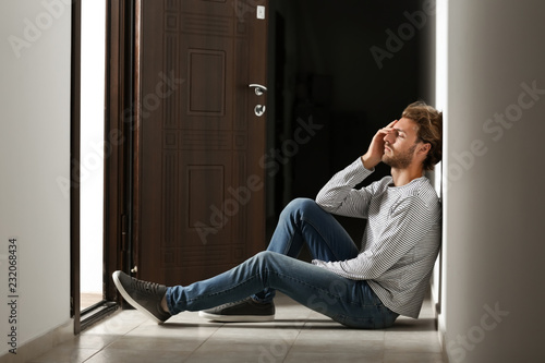 Depressed young man sitting...