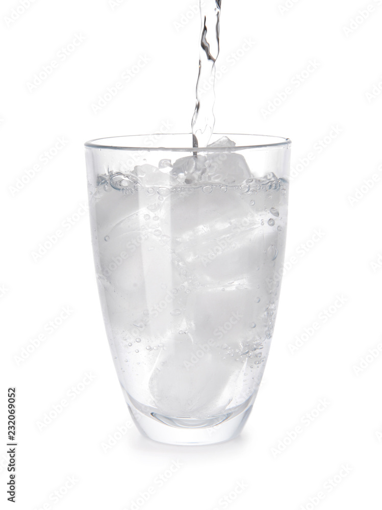 Pouring of water in glass with ice on white background Pouring of water in glass with ice on white background