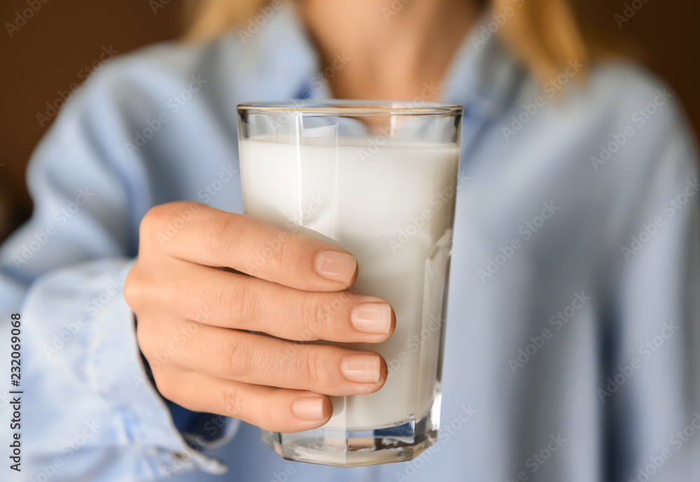 Woman holding glass of delicious milk, closeup Woman holding glass of delicious milk, closeup