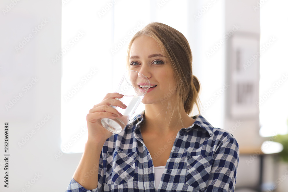 Beautiful young woman drinking water at home Beautiful young woman drinking water at home