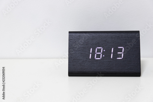 Black digital clock on a white background showing time 18:13