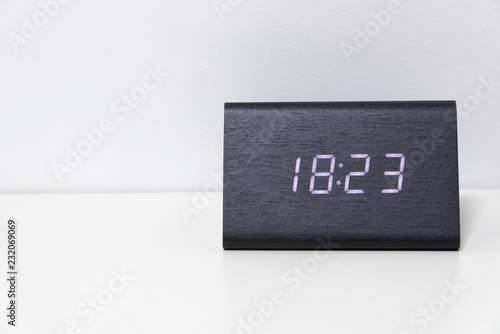 Black digital clock on a white background showing time 18:23 photo