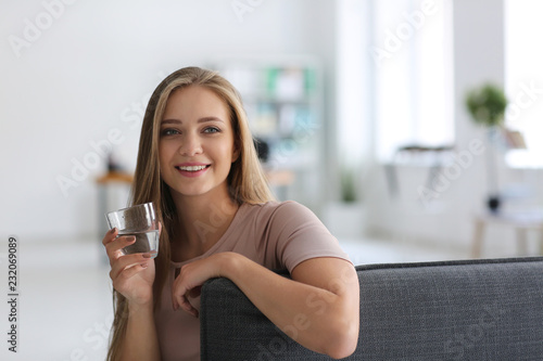 Beautiful young woman drink...