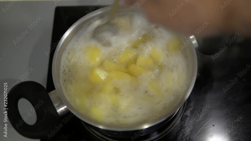 Stir boiled potatoes in a pan Stir boiled potatoes in a pan