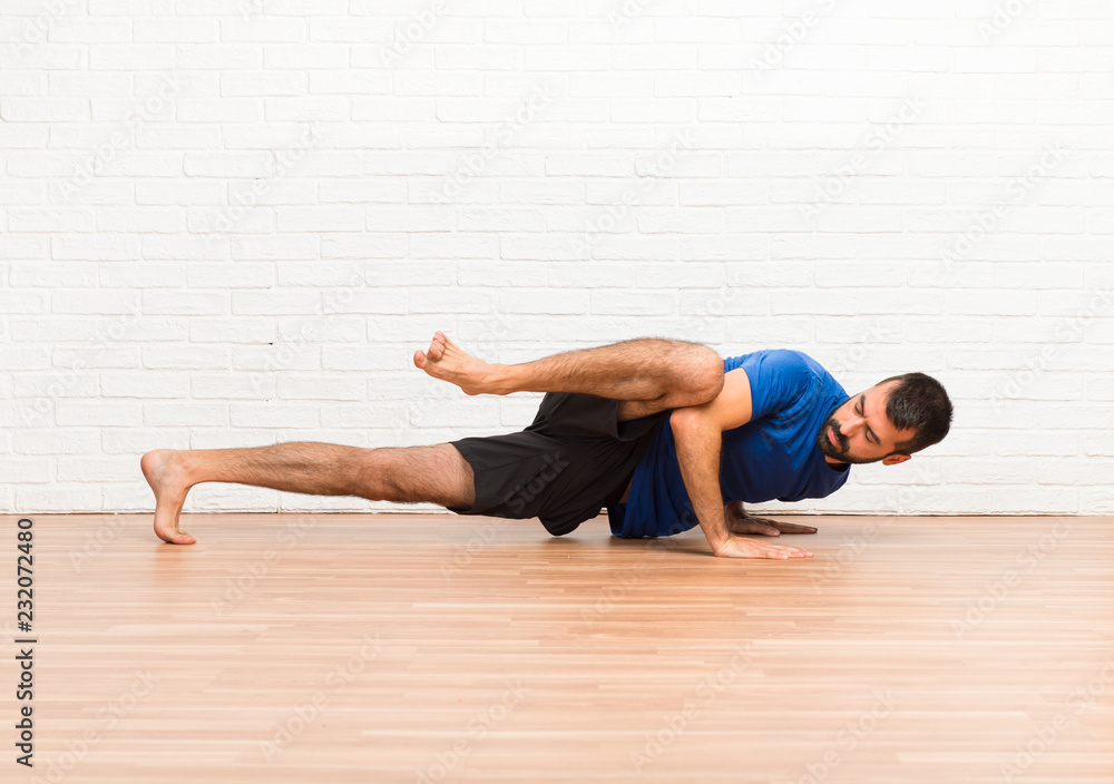 Man doing yoga exercises indoors Man doing yoga exercises indoors