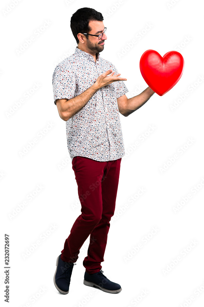 Handsome man with glasses holding a heart icon Handsome man with glasses holding a heart icon