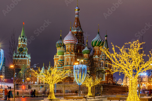 Night view of Spasskaya Tower, Moscow Kremlin and Saint Basil s Cathedral in Moscow, Russia. Architecture and landmarks of Moscow. Moscow with Christmas decoration. photo