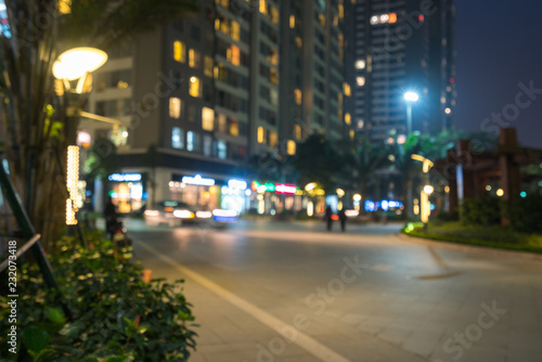 Blurred modern urban city at night with street traffic