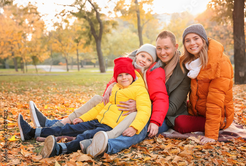 Happy family in autumn park