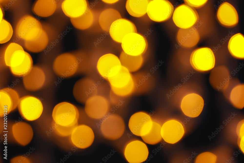 Glowing Christmas lights on dark background, blurred view Glowing Christmas lights on dark background, blurred view